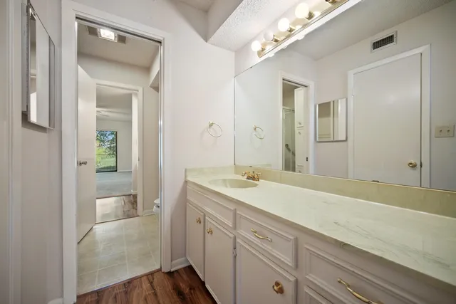 a en suite bathroom with a sink and mirror