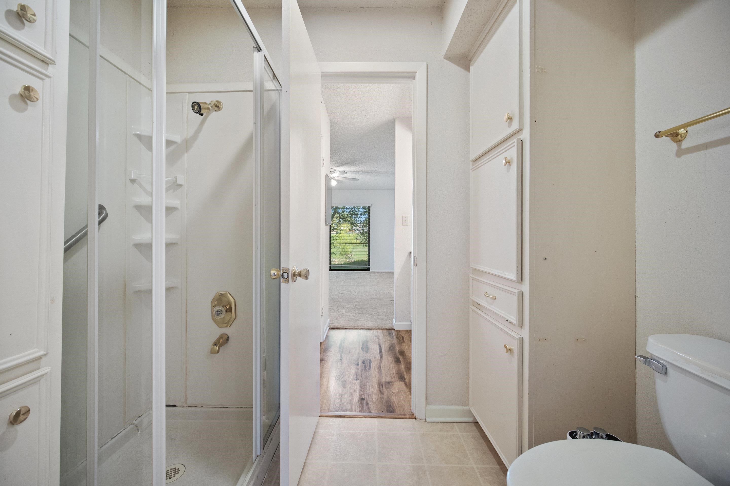 1201 Ranch Road 1431, Unit 2 Marble Falls, TX 78654 - Photo 19 of 26 a bathroom with a shower and toilet