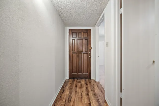 a view of a room with wooden floor and closet
