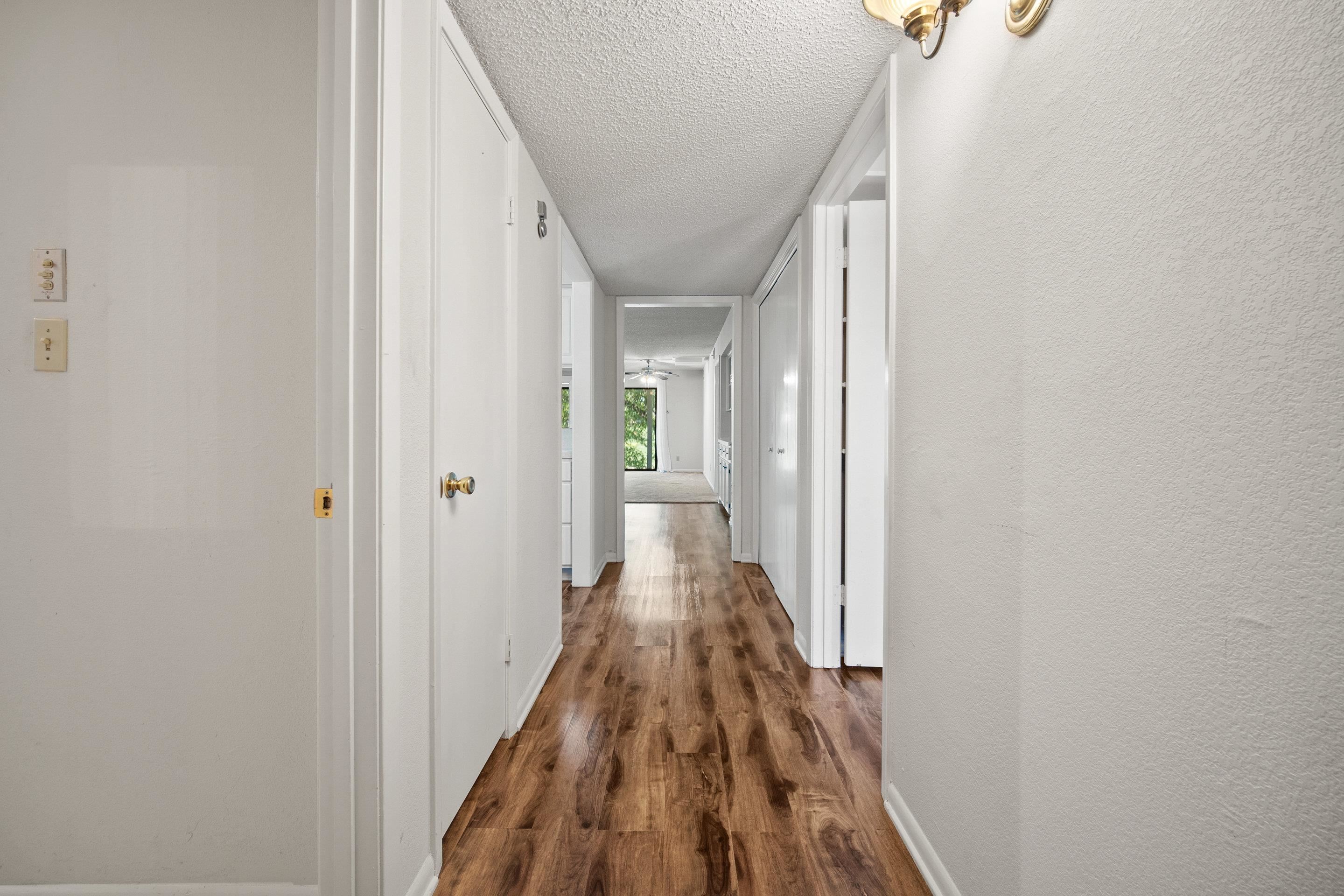 1201 Ranch Road 1431, Unit 2 Marble Falls, TX 78654 - Photo 3 of 26 a view of a hallway with wooden floor and staircase