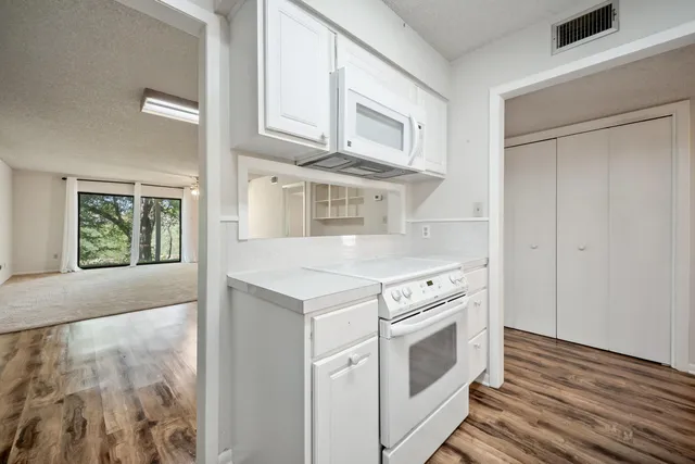 a view of washer and dryer with wooden floor