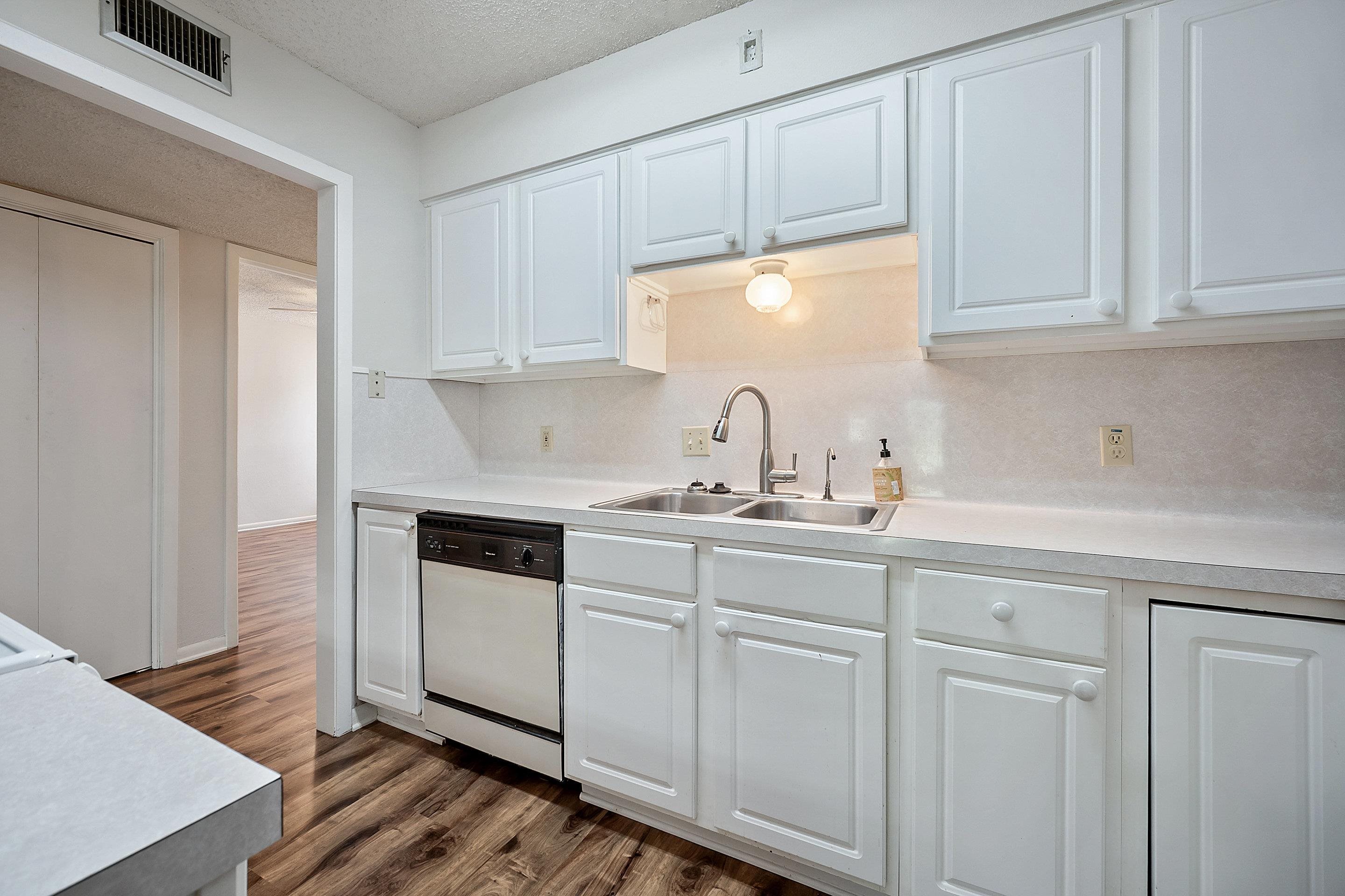 1201 Ranch Road 1431, Unit 2 Marble Falls, TX 78654 - Photo 6 of 26 a kitchen with white cabinets and white appliances
