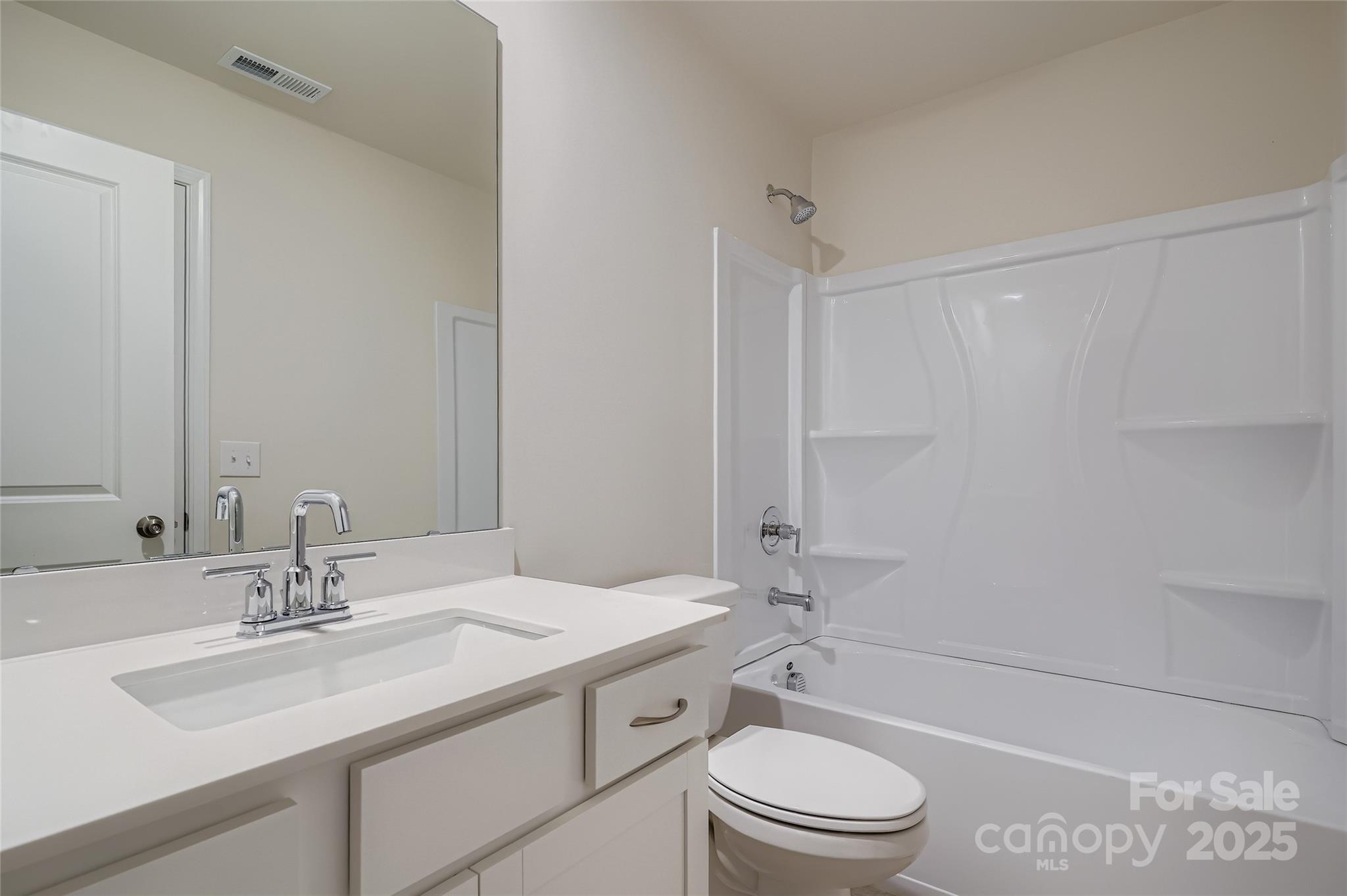 4356 Shimmering Stone Way Maiden, NC 28650 - Photo 11 of 13 a bathroom with a granite countertop sink a toilet a mirror and shower