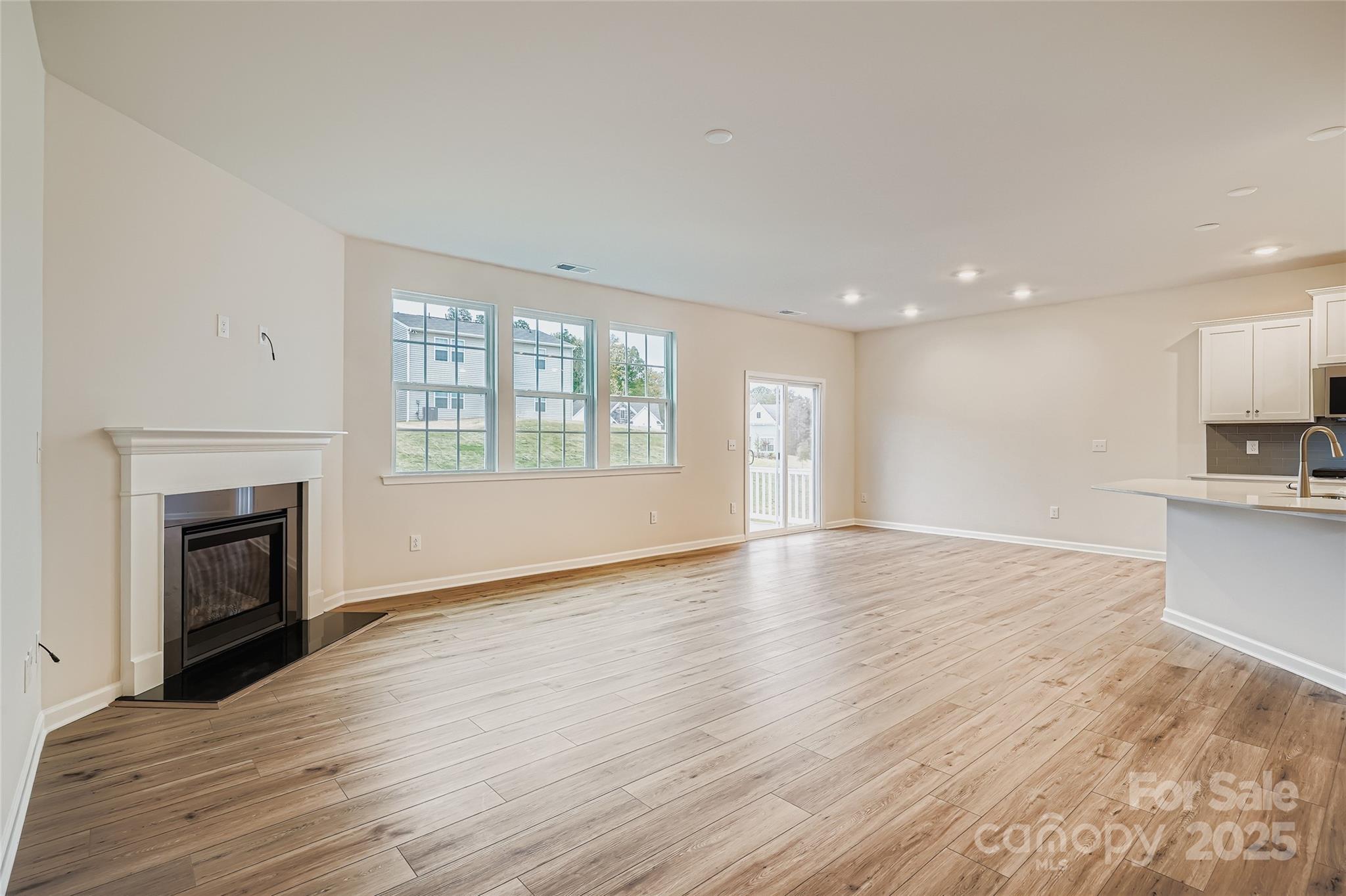 4356 Shimmering Stone Way Maiden, NC 28650 - Photo 3 of 13 a view of empty room with wooden floor and fireplace