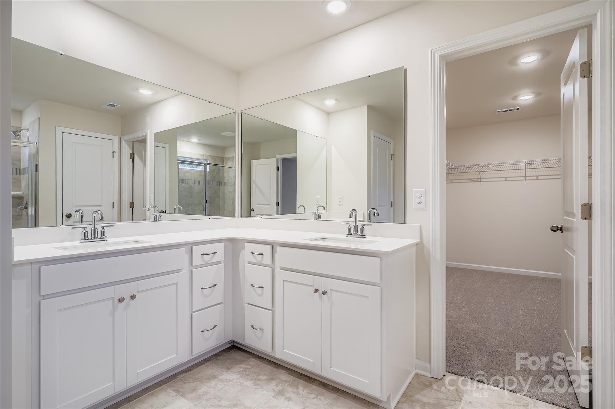 4356 Shimmering Stone Way Maiden, NC 28650 - Photo 7 of 13 a bathroom with a double vanity sink mirror and shower