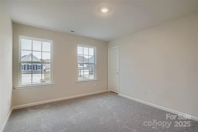 a bathroom with a granite countertop sink a toilet a mirror and shower