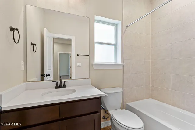 a bathroom with a sink toilet vanity and shower