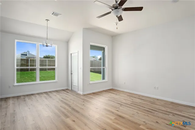 a view of a room with wooden floor and white walls