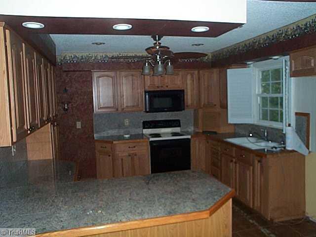 2877 Millwheel Road Pfafftown, NC 27040 - Photo 3 of 10 Kitchen. granite counter tops, ample cabinet space, tile backsplash