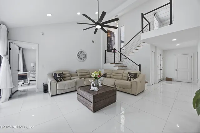 a large bedroom with a large bed and a flat screen tv