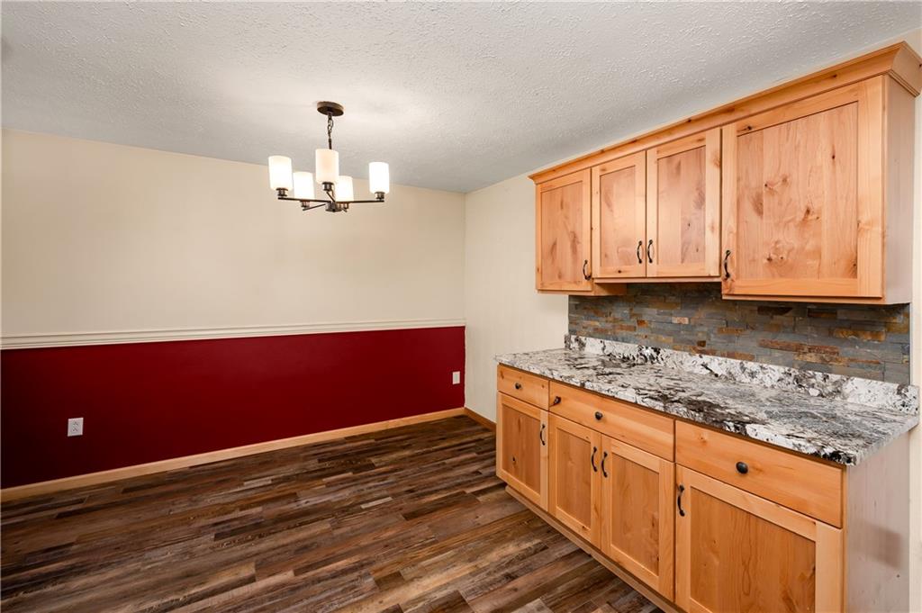 201 Colleen Street Butler, PA 16001 - Photo 14 of 33 a kitchen with stainless steel appliances granite countertop a stove a sink dishwasher and wooden cabinets with wooden floor