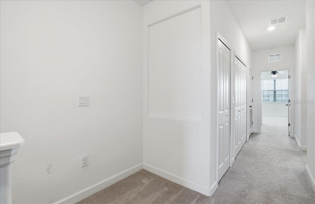 14740 Lyla Terrace Lakewood Ranch, FL 34211 - Photo 19 of 68 a view of a hallway with wooden shelves