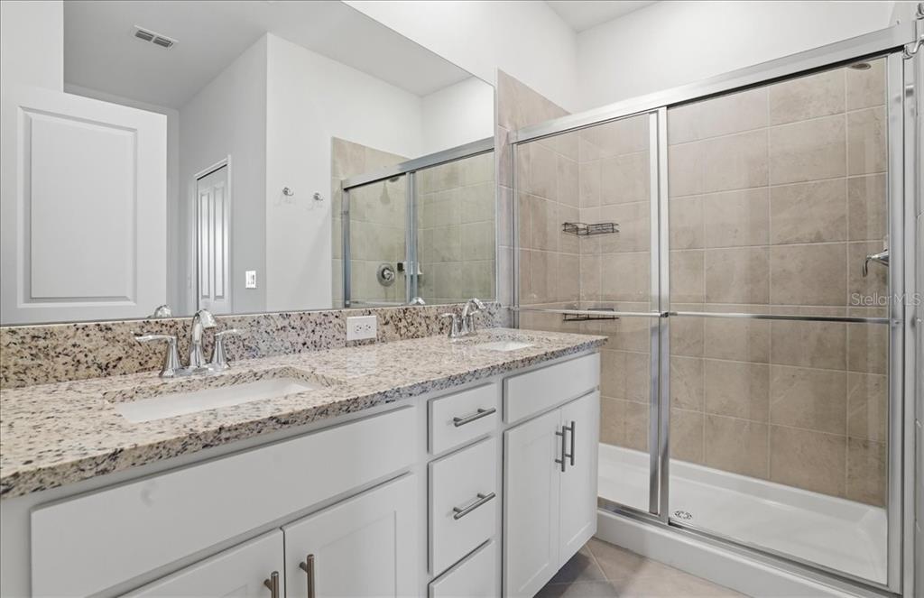 14740 Lyla Terrace Lakewood Ranch, FL 34211 - Photo 22 of 68 a bathroom with a granite countertop sink and a mirror