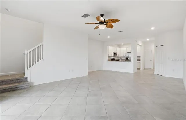a kitchen with granite countertop white cabinets and stainless steel appliances