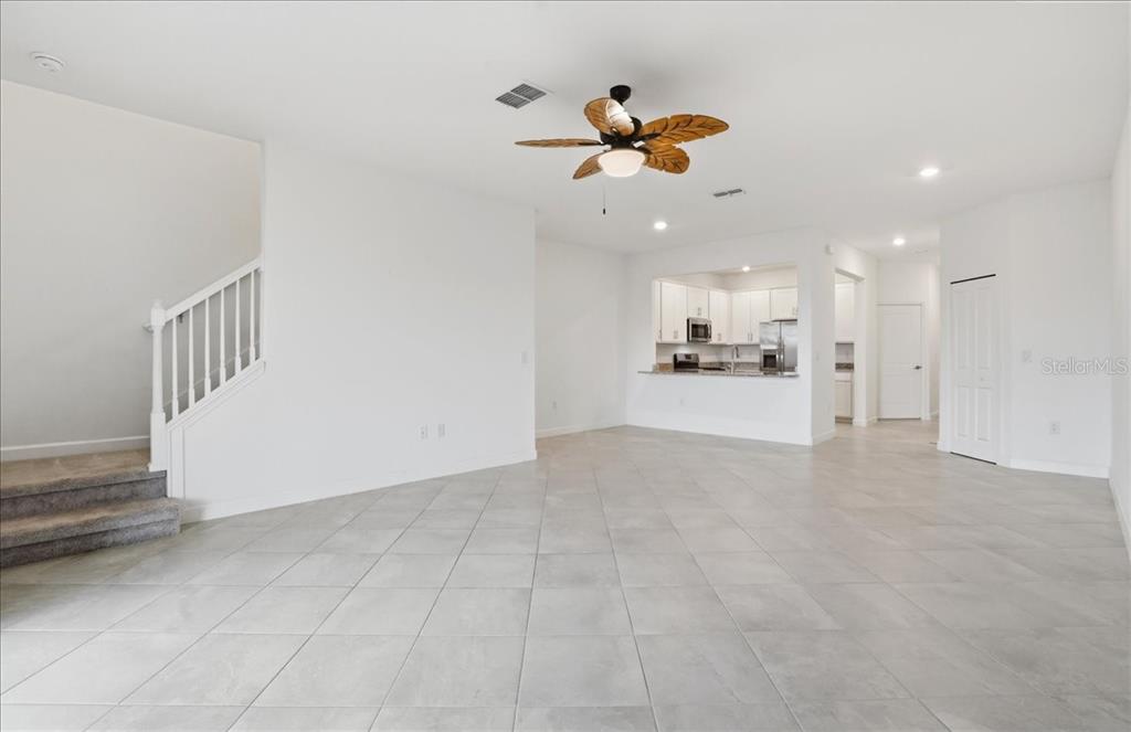 14740 Lyla Terrace Lakewood Ranch, FL 34211 - Photo 5 of 68 a view of a livingroom with a ceiling fan and kitchen space
