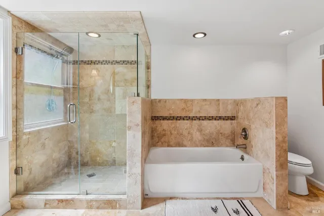 a bathroom with a bathtub and a shower