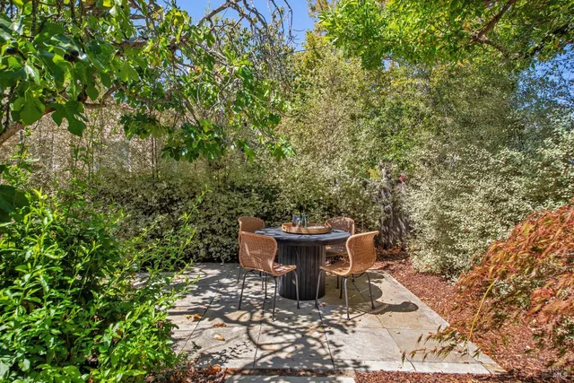 a view of a backyard with sitting area
