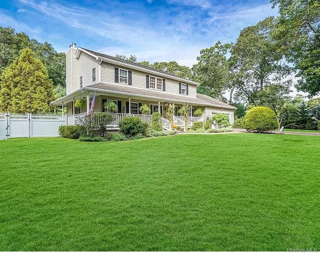 64 Beachfern Road Center Moriches, NY 11934 - Photo 1 of 12 a front view of a house with a yard table and trees