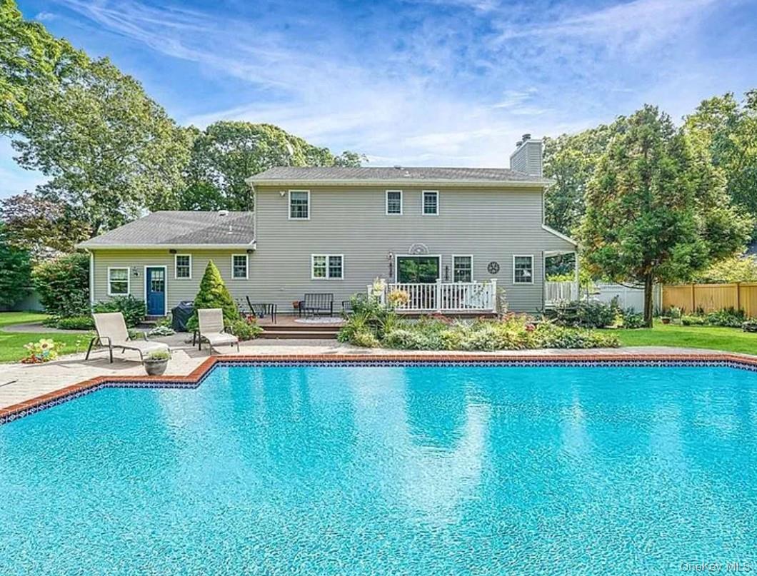 64 Beachfern Road Center Moriches, NY 11934 - Photo 12 of 12 a view of swimming pool with lawn chairs and plants