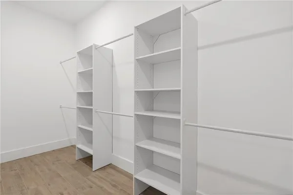 a bathroom with a white tub a double vanity sink and mirror