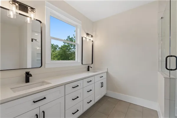 an empty room with a window and a ceiling fan