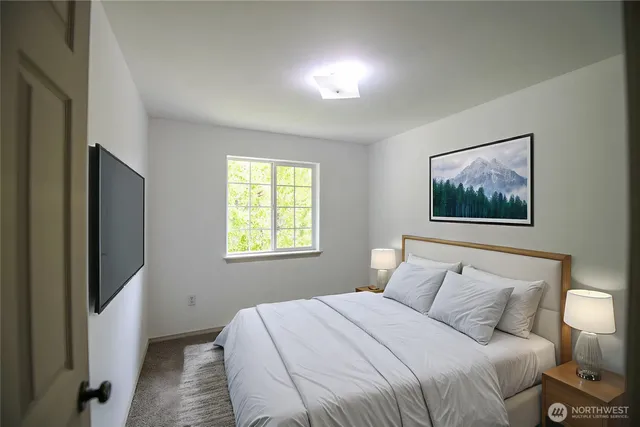 a bedroom with a bed and a flat screen tv