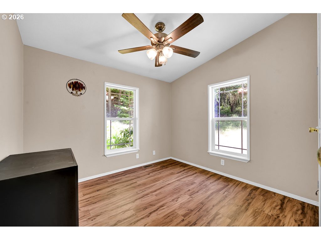 35235 Row River Road Cottage Grove, OR 97424 - Photo 23 of 28 a view of an empty room with wooden floor and a window