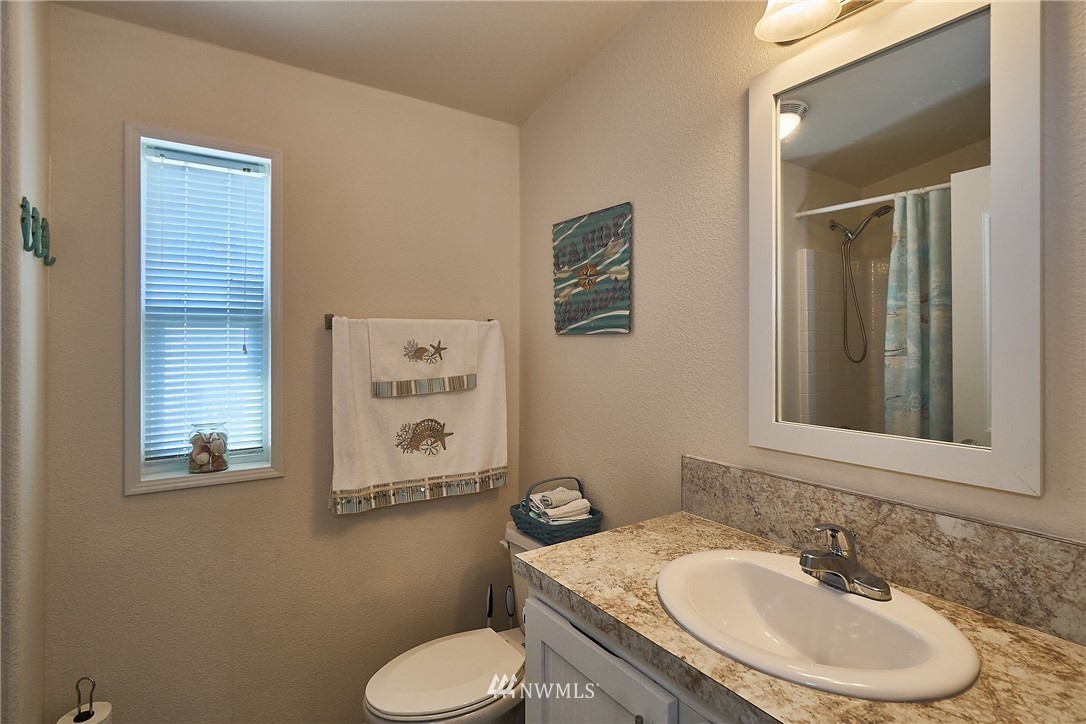 15256 Pine Drive Renton, WA 98058 - Photo 11 of 15 a bathroom with a granite countertop toilet sink and mirror