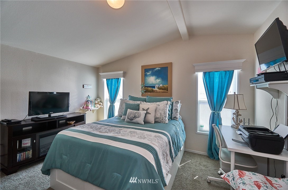 15256 Pine Drive Renton, WA 98058 - Photo 12 of 15 a bedroom with a bed and a flat screen tv