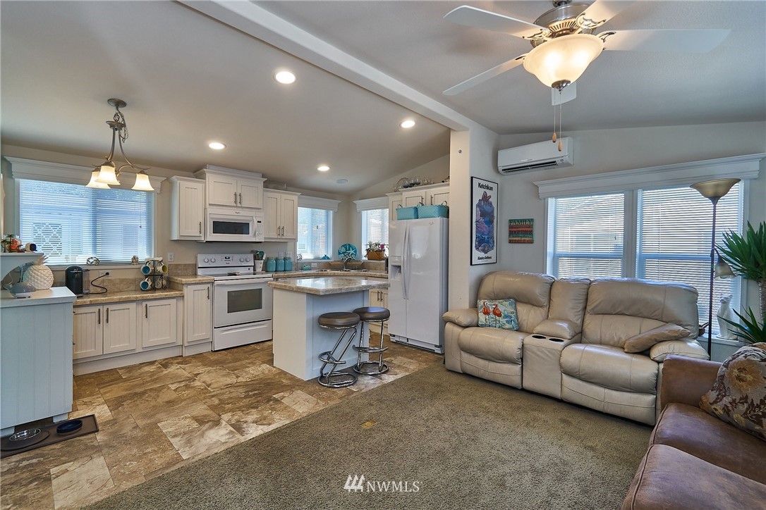 15256 Pine Drive Renton, WA 98058 - Photo 7 of 15 a living room with kitchen island furniture and a kitchen view