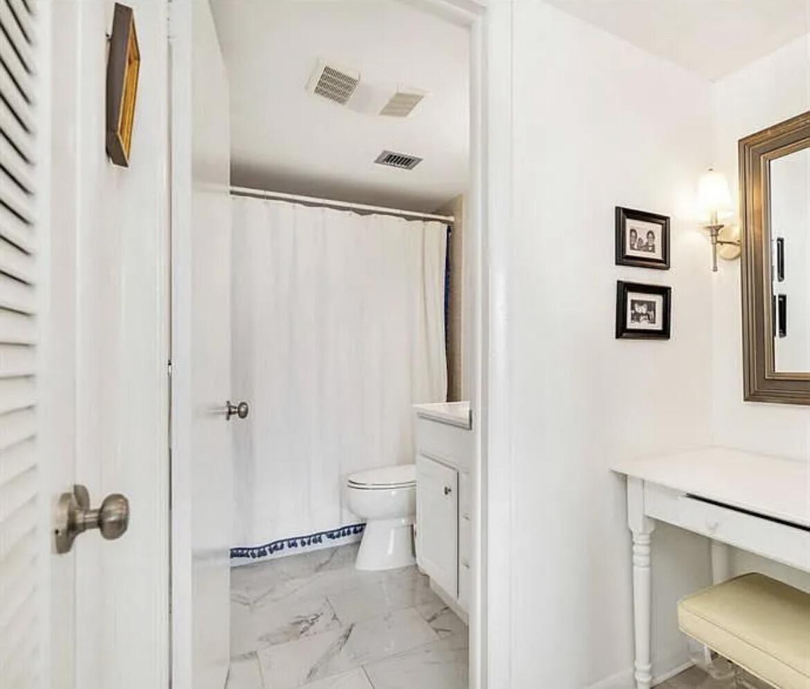 3800 Washington Road, Unit 310 West Palm Beach, FL 33405 - Photo 5 of 15 a bathroom with a shower and a toilet