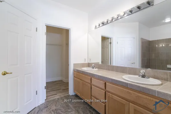 a bathroom with a granite countertop sink and a mirror