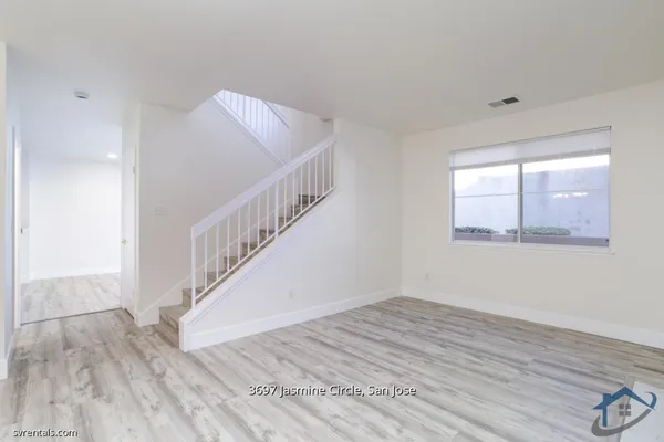 a view of room with window and hardwood floor