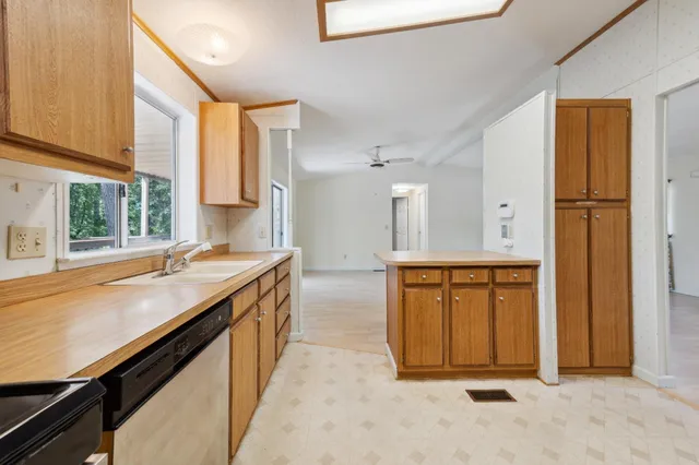 a bathroom with a granite countertop sink and a large mirror