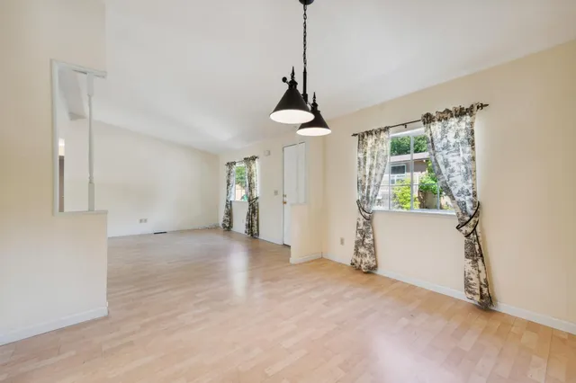 a view of a room with a windows and ceiling fan