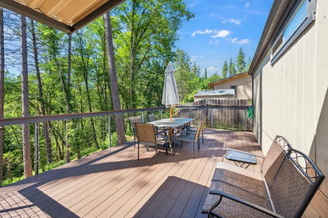 a view of a patio with table and chairs and wooden floor