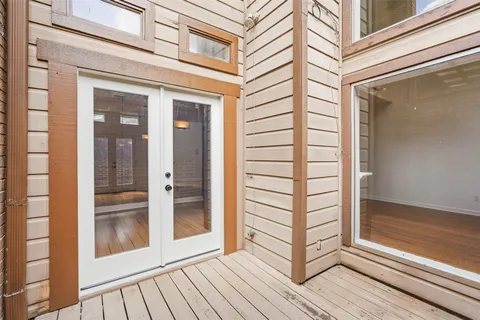 a view of a room with a window and wooden floor