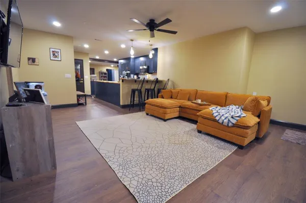 a living room with furniture and kitchen view