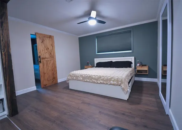 a bedroom with a bed and a chandelier