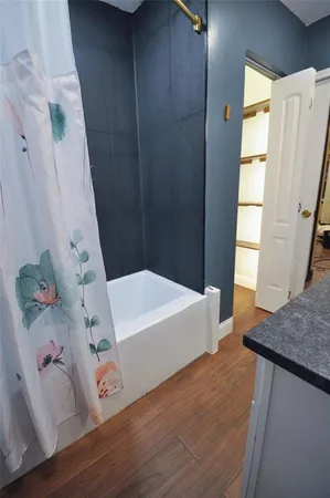 a bathroom with a tub and shower