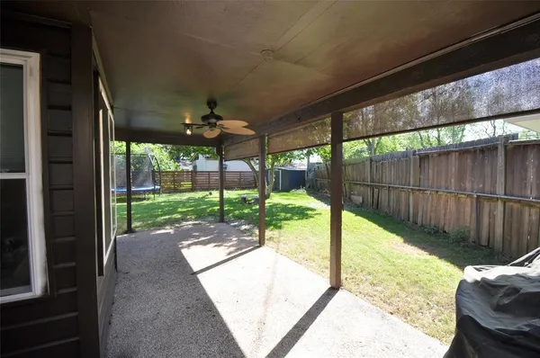 a view of a porch with furniture and garden