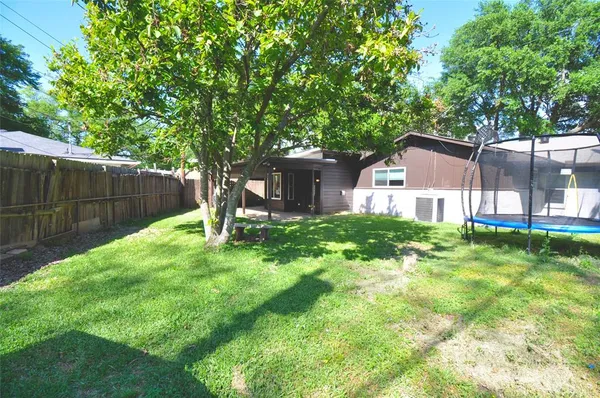 a view of a house with a yard and sitting area