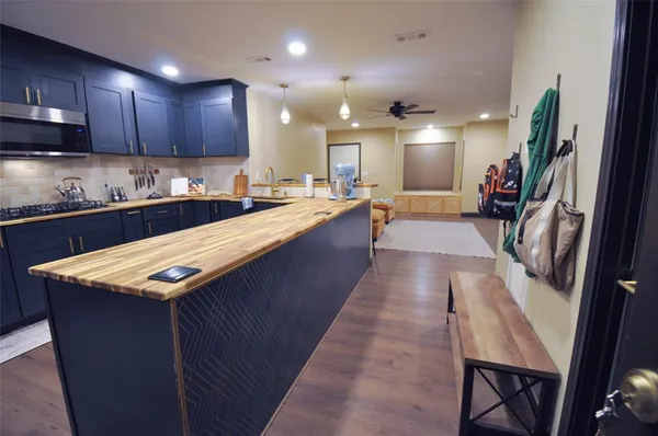 a large kitchen with lots of counter space a sink and appliances