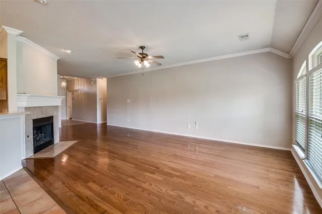 wooden floor in an empty room with a window