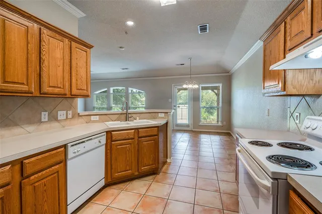 a kitchen with a sink stove top oven and cabinets