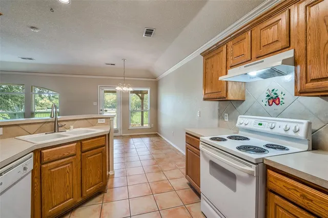 a kitchen that has a sink and a stove