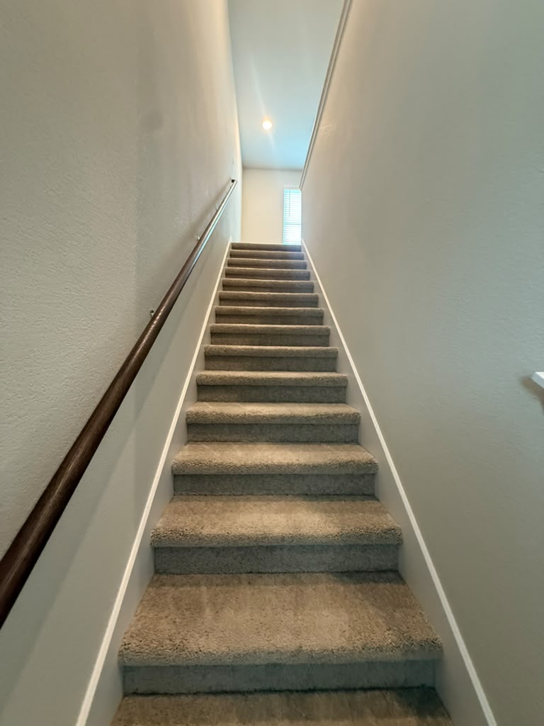 2601 Foss Road Manor, TX 78653 - Photo 27 of 40 A classic carpeted staircase leads to the upper level of the home.