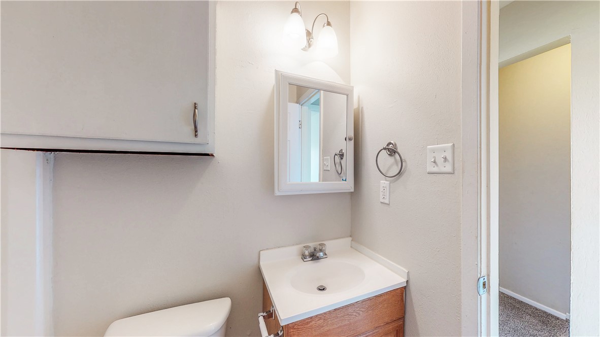2912 Prairie Flower Circle, Unit D Bryan, TX 77802 - Photo 12 of 22 a bathroom with a sink a toilet and a mirror