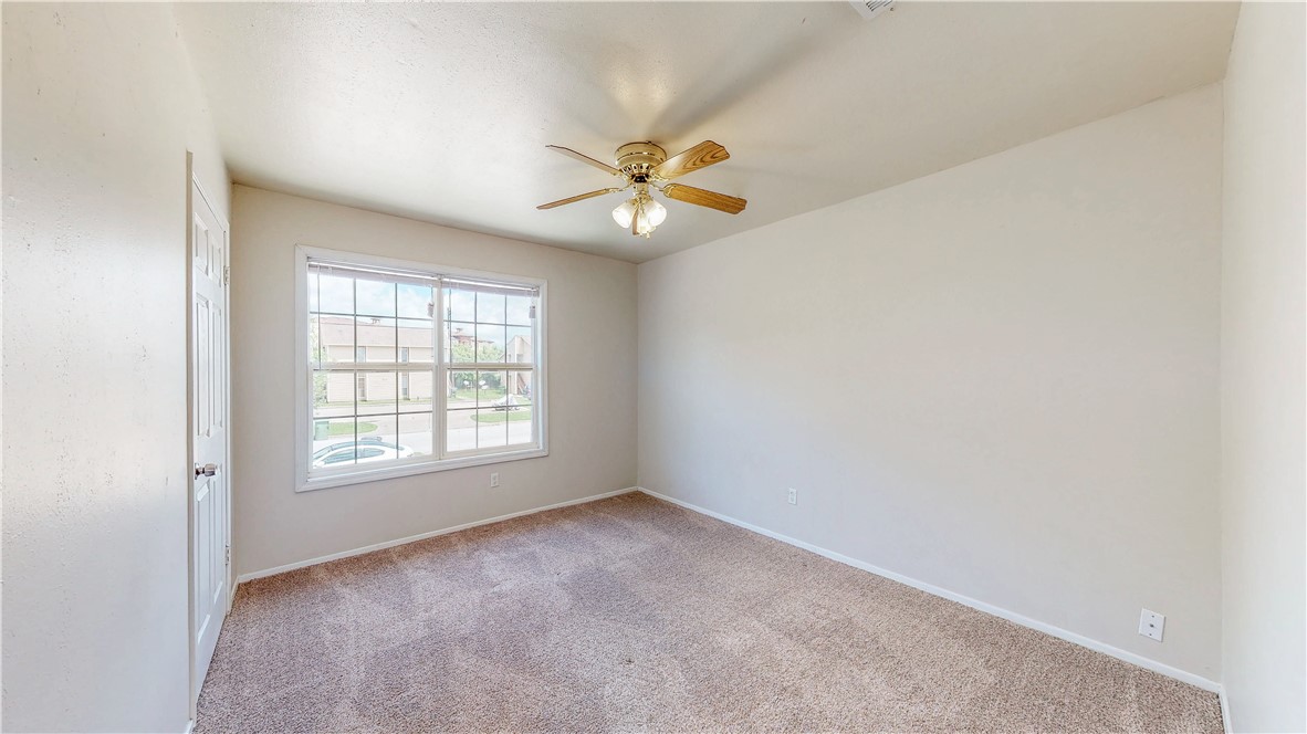 2912 Prairie Flower Circle, Unit D Bryan, TX 77802 - Photo 14 of 22 an empty room with a window and a fan