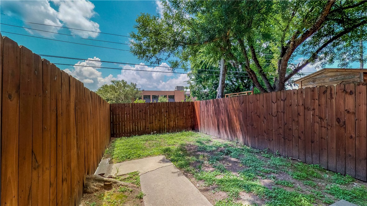 2912 Prairie Flower Circle, Unit D Bryan, TX 77802 - Photo 17 of 22 a view of a backyard with wooden fence